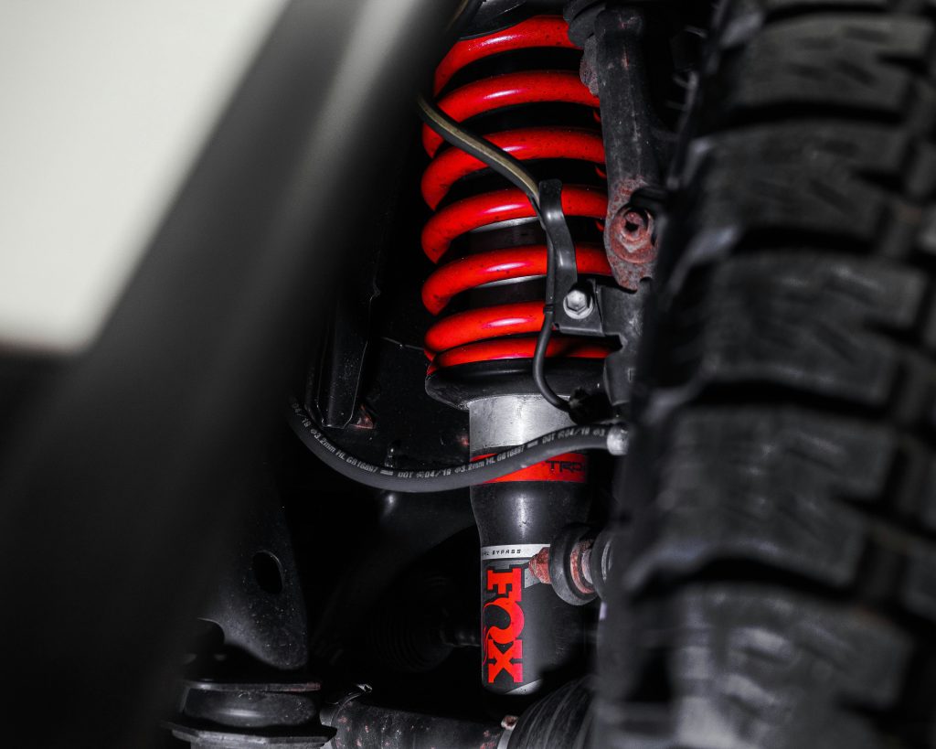 Fox Shocks red coilover suspension on a vehicle at 7 Force Garage Sheffield, England. Automotive suspension upgrade and off-road performance parts.