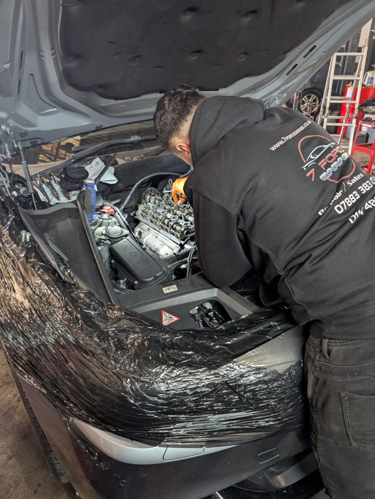Mechanic working on the engine of a car with the hood open at 7 Force Garage Sheffield