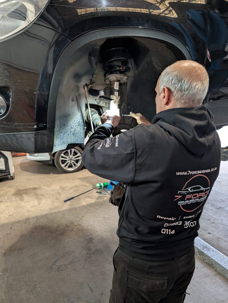 Mechanic working on a car's suspension at 7 Force Garage Sheffield.